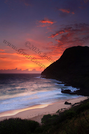 Sunrise and waves wash Makapuu Beach lighthouse Oahu Hawaii