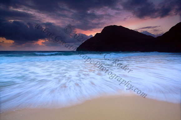 Sunrise and waves wash Makapuu Beach lighthouse Oahu Hawaii