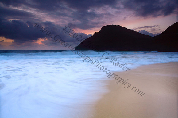 Sunrise and waves wash Makapuu Beach lighthouse Oahu Hawaii