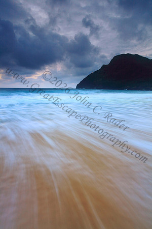 Sunrise and waves wash Makapuu Beach lighthouse Oahu Hawaii