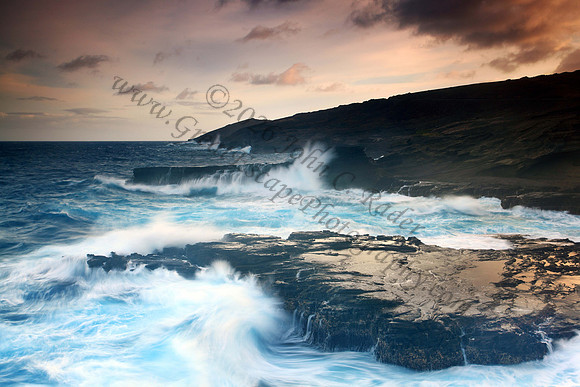 Colorful sunset and big waves crashing on Ka Iwi Coastline Oahu Hawaii