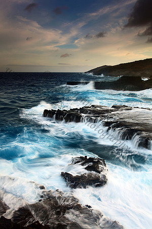 Colorful sunset and big waves crashing on Ka Iwi Coastline Oahu Hawaii