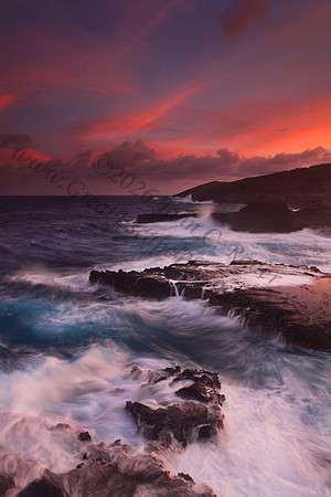 Colorful sunset and big waves crashing on Ka Iwi Coastline Oahu Hawaii