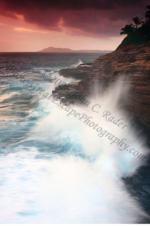 Waves crash on cliffs spitting caves explosions sunset splashing Oahu Hawaii