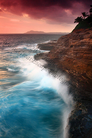 Waves crash on cliffs spitting caves explosions sunset splashing Oahu Hawaii