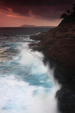 Waves crash on cliffs spitting caves explosions sunset splashing Oahu Hawaii