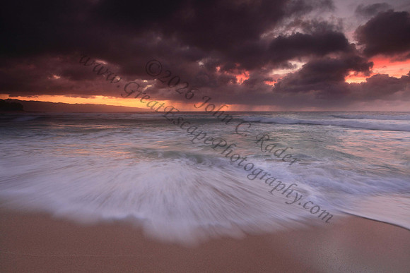 Waves wash North Shore at sunset Oahu Hawaii