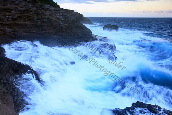 Waves crash on cliffs spitting caves explosions sunset splashing Oahu Hawaii