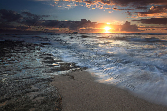 Waves wash North Shore at sunset Oahu Hawaii