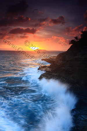 Waves crash on cliffs spitting caves explosions sunset splashing Oahu Hawaii