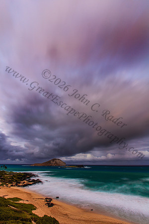 Sunset at Makapuu beach and lighthouse overlooking Rabbit Island on Oahu Hawaii