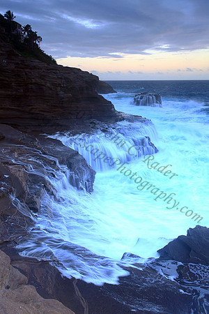 Waves crash on cliffs spitting caves explosions sunset splashing Oahu Hawaii