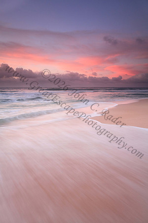Waves wash North Shore at sunset Oahu Hawaii