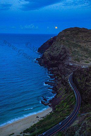 Supermoon rising over makapuu lighthouse and beach, Oahu, Hawaii