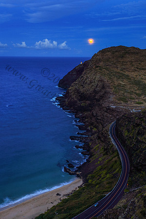 Supermoon rising over makapuu lighthouse and beach, Oahu, Hawaii
